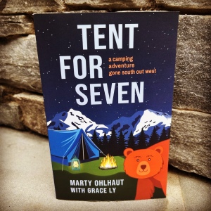 Book cover for Tent For Seven featuring a tent, mountains, fire, and a smiling bear.